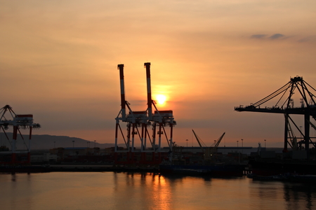 Container Terminal and vessels underway. Saigon Port, Vietnam. View of the terminal and cranes at sunrise.の写真素材