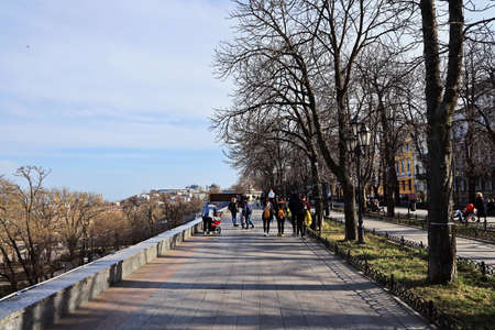 Odessa, Ukraine. March, 2020. Family Day. Parents' active leisure on foot with children in wheelchairs, roller skates, bicycles on city streets and in the park.のeditorial素材