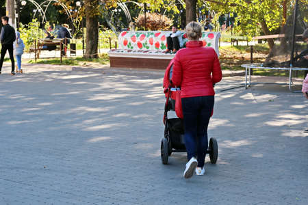 Odessa, Ukraine. March, 2020. Family Day. Parents' active leisure on foot with children in wheelchairs, roller skates, bicycles on city streets and in the park.のeditorial素材