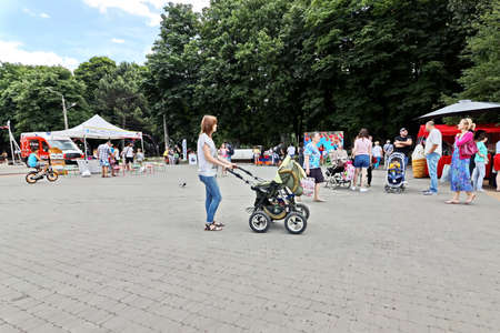 Odessa, Ukraine. March, 2020. Family Day. Parents' active leisure on foot with children in wheelchairs, roller skates, bicycles on city streets and in the park.のeditorial素材