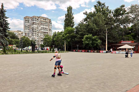 Odessa, Ukraine. March, 2020. Family Day. Parents' active leisure on foot with children in wheelchairs, roller skates, bicycles on city streets and in the park.のeditorial素材