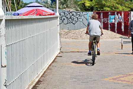 Odessa, Ukraine. October, 2018. Family Day. Parents' active leisure on foot with children in wheelchairs, roller skates, bicycles on city streets and in the park.のeditorial素材