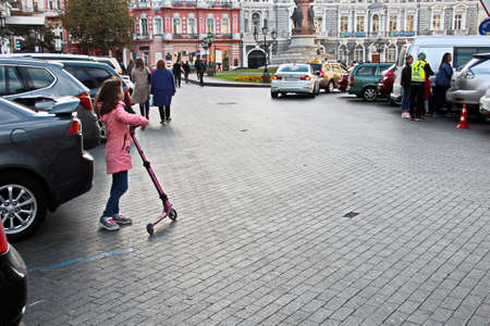 Odessa, Ukraine. October, 2018. Family Day. Parents' active leisure on foot with children in wheelchairs, roller skates, bicycles on city streets and in the park.のeditorial素材