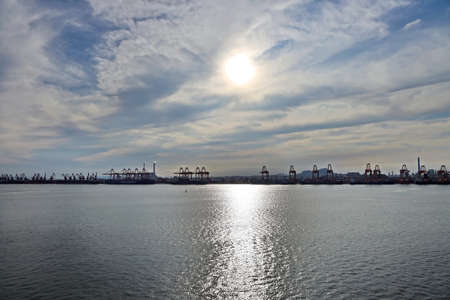 Panoramic views of piers, sea vessels, tugboats and the city of Rizhao, China.