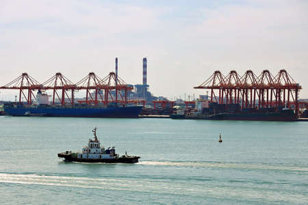 Panoramic views of piers, sea vessels, tugboats and the city of Rizhao, China.