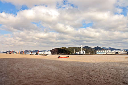 Cargo terminal for unloading grain cargo to coastal cranes. Port Zhoushan, China. November, 2019
