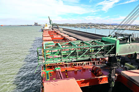 Cargo terminal for loading coal cargos by shore cranes. Port Gladstone, Australia. December, 2019.