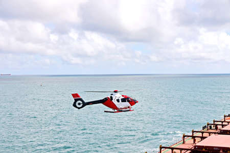 A helicopter used to receive a pilot on a sea vessel. Gladstone QLD, Australia