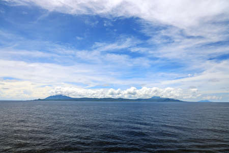 Seascape, blue sky, clouds and sea in the tropical waters of the Pacific Ocean.
