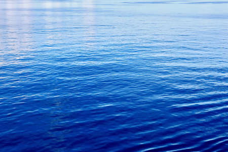 The water surface of the ocean in calm weather as a background.