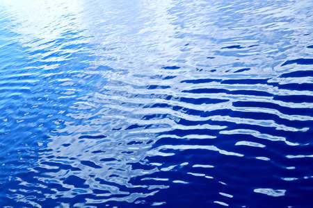 The water surface of the ocean in calm weather as a background.