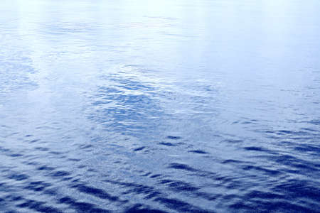 The water surface of the ocean in calm weather as a background.