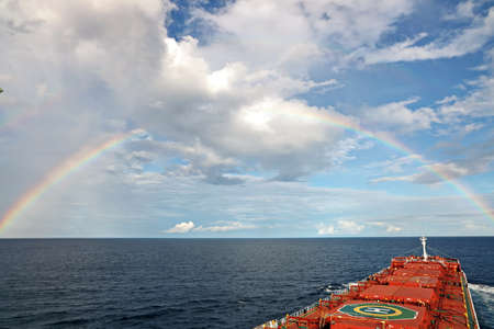 Rainbow in the ocean after rain and thunderstorm. North Pacific Ocean.の写真素材