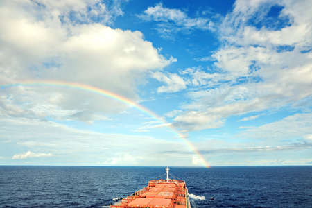 Rainbow in the ocean after rain and thunderstorm. North Pacific Ocean.の写真素材