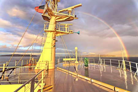 Colorful views of the rainbow against the sky, clouds and sea horizon. Commencement Bay, Tacoma, WA,...