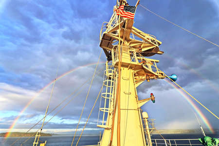Colorful views of the rainbow against the sky, clouds and sea horizon. Commencement Bay, Tacoma, WA,...