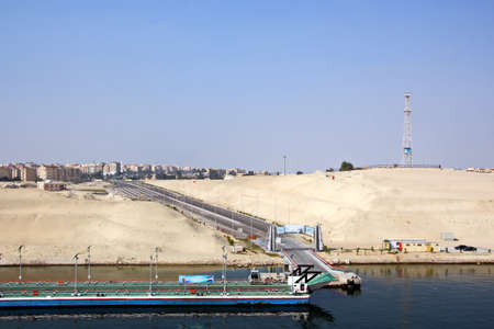 Passage through the Suez Canal by large sea vessels.Panoramic view of the coast and canal in the bays of Suez.の写真素材
