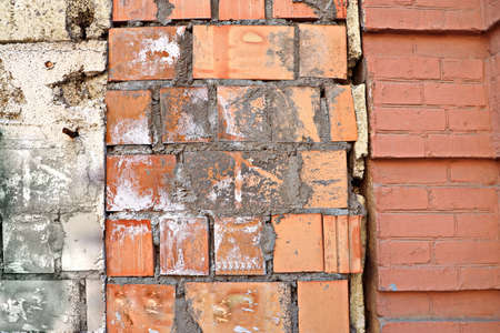Stone laying, bricks, shell rock and cement coating used in the architecture of the background and...