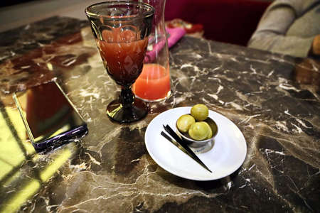 Food and drink. A glass of cold wine and juice. Close-up view of glasses of cold wine and juices in...