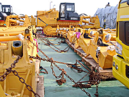 Shanghai, China, October 24, 2008. Loading heavy equipment and trucks aboard a Ro-Ro vessel in the...