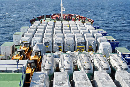 Shanghai, China, October 24, 2008. Loading heavy equipment and trucks aboard a Ro-Ro vessel in the...