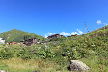 Landscape views of the Caucasus Mountains, river and villages. Peak and river Enguri. Georgia....