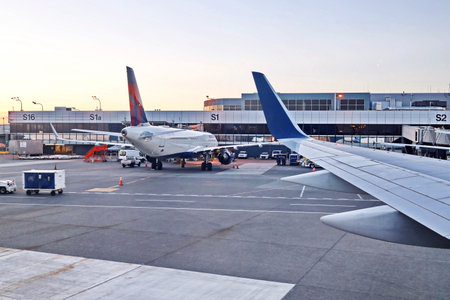 New York & Seatle, USA. 18 August 2020. Airport terminal. Plane landing and taxiing to the place of...