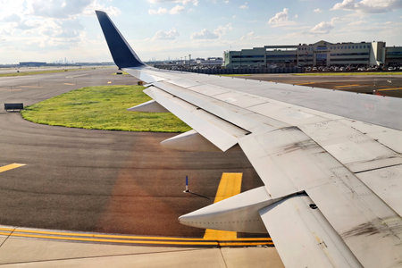 New York & Seatle, USA. 18 August 2020. Airport terminal. Plane landing and taxiing to the place of disembarkation of passengers.のeditorial素材