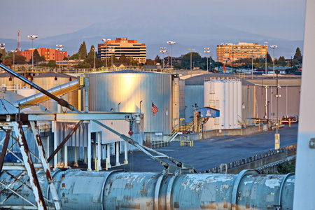 Cargo terminal for loading bulk cargo of cooper concentrates by shore cranes. View of piers and vessels under loading operation. Vancouver, WA, USA. August, 2020.の写真素材