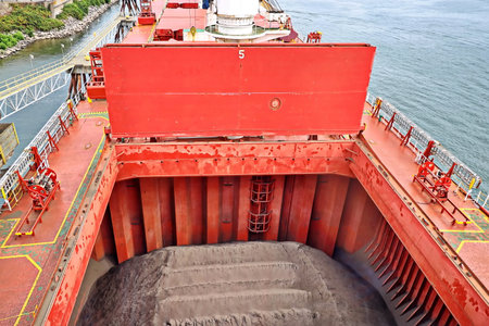 Cargo terminal for loading bulk cargo of cooper concentrates by shore cranes. View of piers and vessels under loading operation. Vancouver, WA, USA. August, 2020.の写真素材