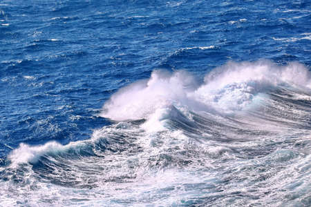Storm waves in the world ocean. Kind of waves, crests, splashes, foam against the background of the...