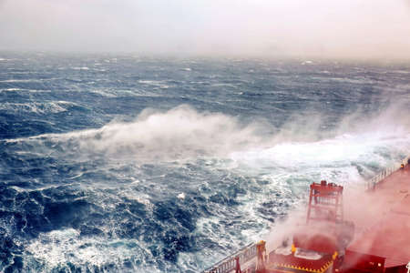 Storm waves in the world ocean. Kind of waves, crests, splashes, foam against the background of the...