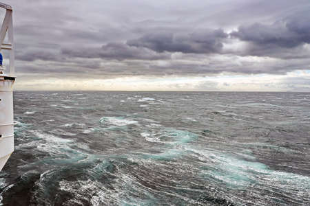 Storm waves in the world ocean. Kind of waves, crests, splashes, foam against the background of the...