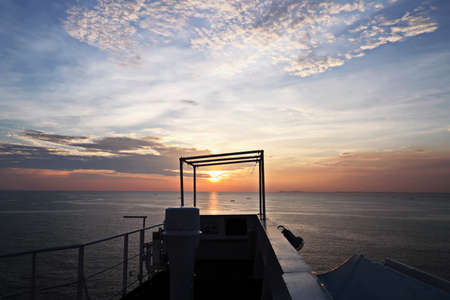 Sunset in the Pacific Ocean. Different types of sunset from the side of the ship while driving and anchoring at the port. Riot of colors of the ocean, clouds and sun.の写真素材