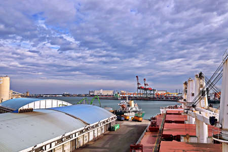 Port of Taichung, Taiwan, September, 24,2020. Cargo terminal for unloading bulk cargoes by shore cranes. Views of the pier and vessels under discharging operations.のeditorial素材