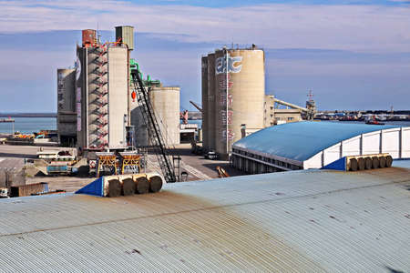 Port of Taichung, Taiwan, September, 24,2020. Cargo terminal for unloading bulk cargoes by shore cranes. Views of the pier and vessels under discharging operations.のeditorial素材