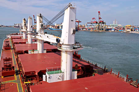 Port of Taichung, Taiwan. September, 24, 2020. Seagoing vessels, tugboats at the port under cargo...