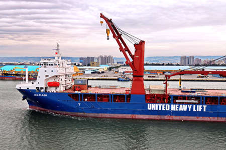 Port of Taichung, Taiwan. September, 24, 2020. Seagoing vessels, tugboats at the port under cargo...