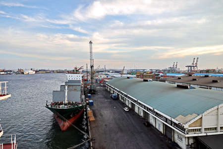 Port of Taichung, Taiwan. September, 24, 2020. Seagoing vessels, tugboats at the port under cargo operations and underway.のeditorial素材