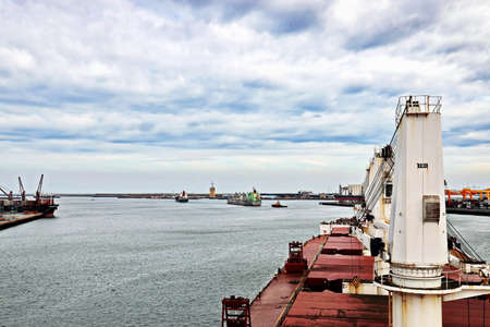Port of Taichung, Taiwan. September, 24, 2020. Seagoing vessels, tugboats at the port under cargo operations and underway.のeditorial素材
