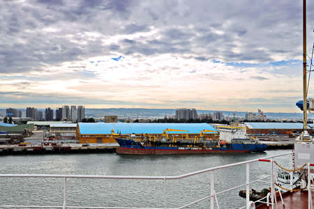 Port of Taichung, Taiwan. September, 24, 2020. Seagoing vessels, tugboats at the port under cargo operations and underway.のeditorial素材