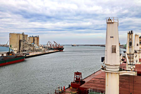Port of Taichung, Taiwan. September, 24, 2020. Seagoing vessels, tugboats at the port under cargo operations and underway.のeditorial素材