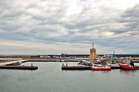 Port of Taichung, Taiwan. September, 24, 2020. Seagoing vessels, tugboats at the port under cargo operations and underway.のeditorial素材