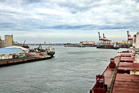 Port of Taichung, Taiwan. September, 24, 2020. Seagoing vessels, tugboats at the port under cargo operations and underway.のeditorial素材