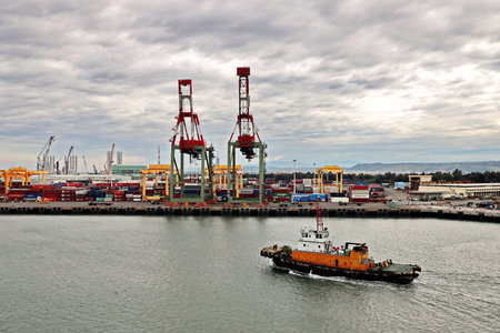 Port of Taichung, Taiwan. September, 24, 2020. Seagoing vessels, tugboats at the port under cargo operations and underway.のeditorial素材