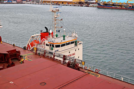 Port of Taichung. Taiwan, September, 24, 2020. Bunkering operations at the port. Bunker barge alongside of vessel and underway.のeditorial素材