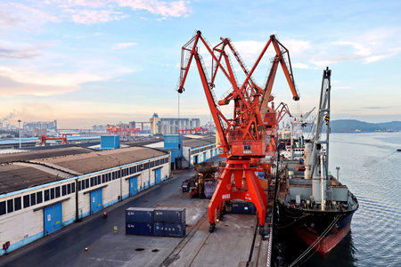Fangcheng, China, September 30,2020. Cargo terminal for unloading bulk cargoes by shore cranes and grabs.のeditorial素材