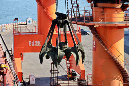 Fangcheng, China, September 30,2020. Cargo terminal for unloading bulk cargoes by shore cranes and...