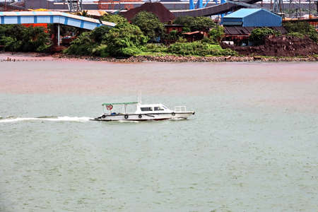 Seagoing vessels, tugboats at the port under cargo operations and underway. Paradeep, India,...
