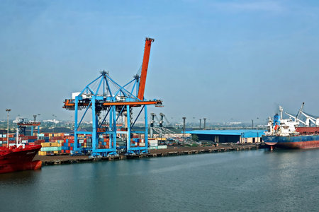 Haldia, India, October, 27, 2020. Cargo terminal for unloading bulk cargo of limestone by shore cranes and grabs. Views of cargo equipment for discharging of bulk cargoes.のeditorial素材